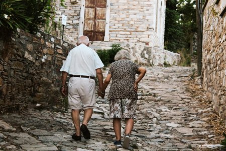 free-photo-of-elderly-couple-walking-on-street-in-village.jpeg
